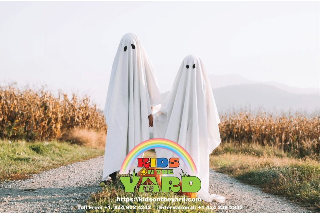 Two children wearing simple yet effective ghost costumes, made with just a white sheet.
