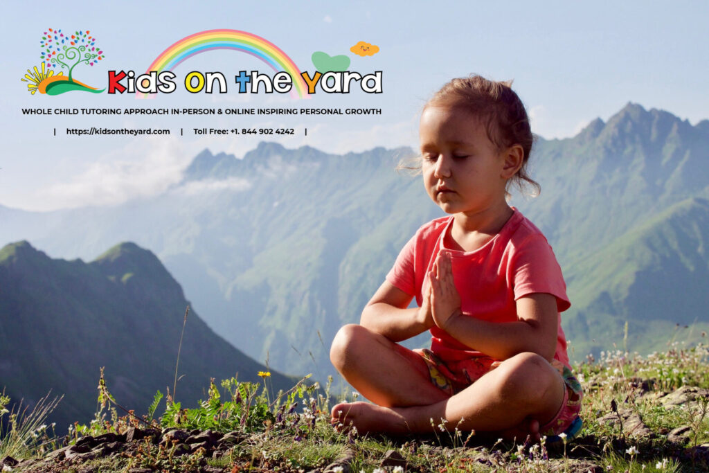 Cute little girl meditating on the top of mountain. Child doing yoga exercise in lotus pose.