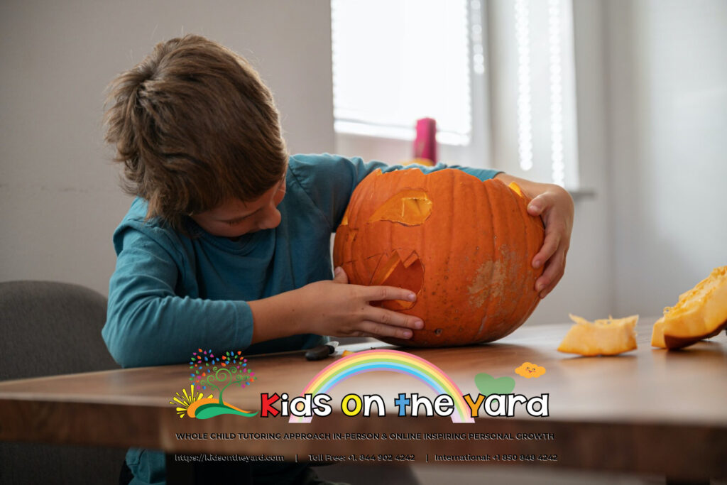 Schoolboy making his own halloween pumpkin