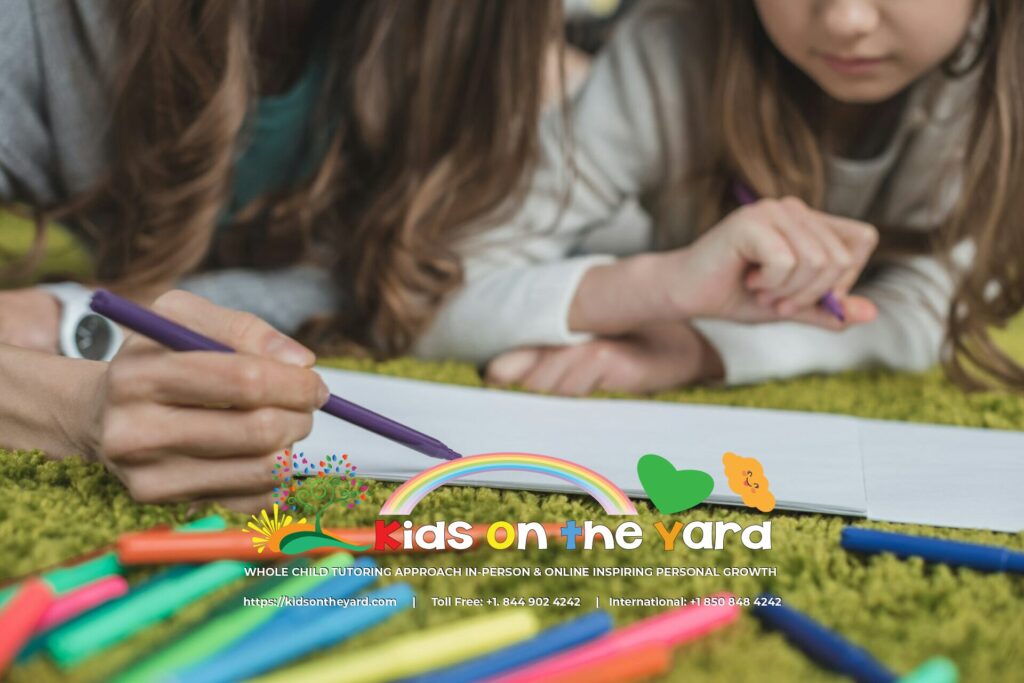 cropped image of mother and daughter drawing on the floor with felt-tip pens