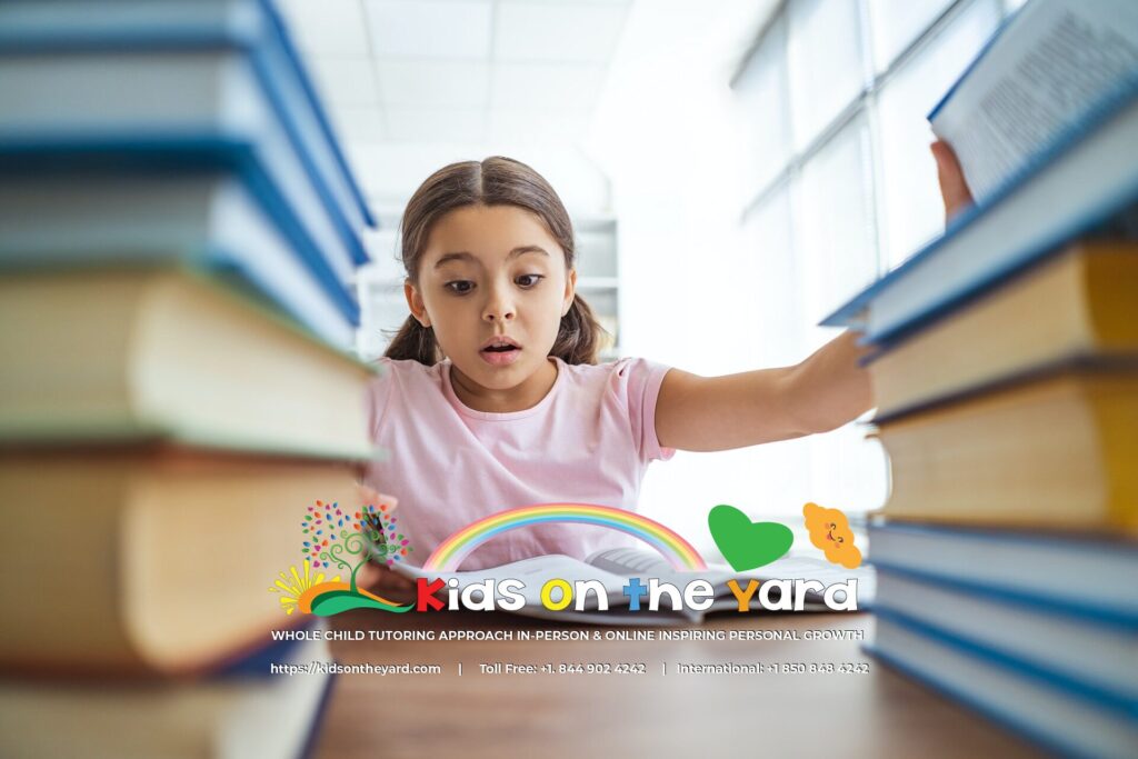 The schoolgirl sitting on the desk with books