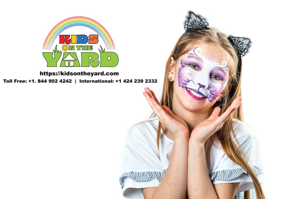 Girl dressed as a cat for Halloween using face paint for features like whiskers and a nose.